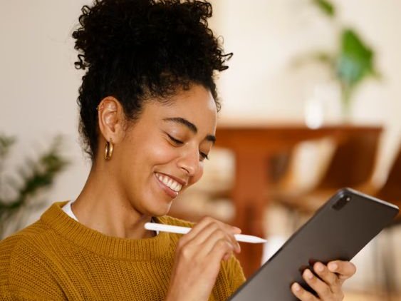 Smiling woman reviewing her budget on a tablet